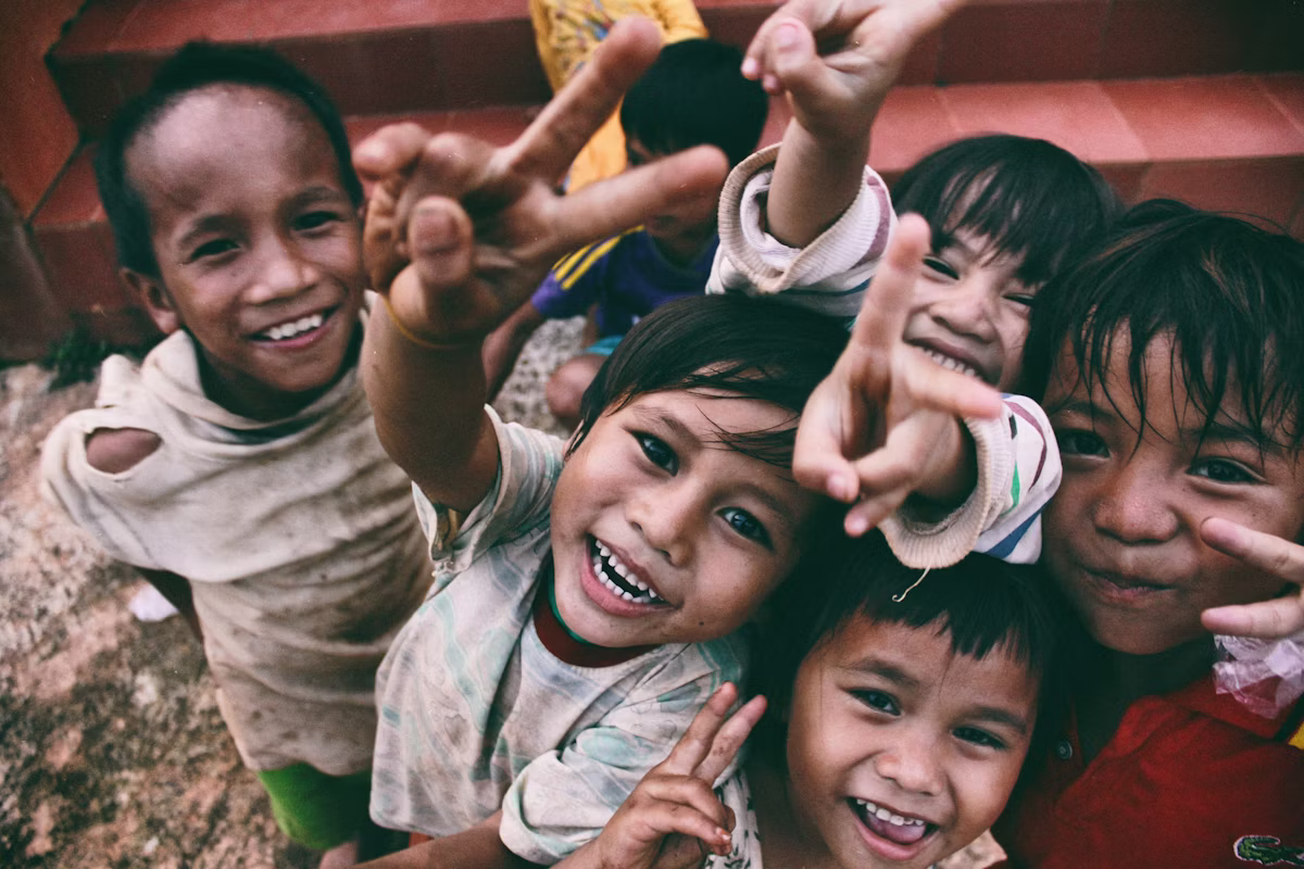 Children smiling at a foundation outreach program